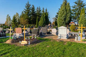 Fototapeta na wymiar Cemetery with visible tombstones and crosses on a sunny day.