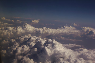 Fototapeta na wymiar Top view of clouds from an airplane window on a sunny day