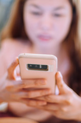 A young woman using an smartphone indoor