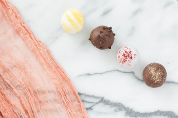Assorted truffles on white marble background