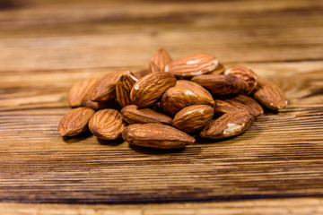 Heap of the peeled almond nuts on wooden table