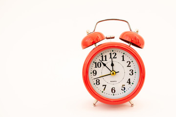 red alarm clock on white background