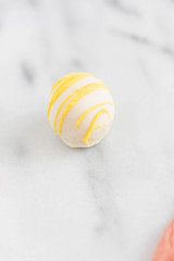 Lemon curd truffle on marble background