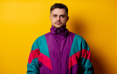 Style man in 90s tracksuit on yellow background