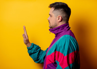 Style man in 90s tracksuit on yellow background
