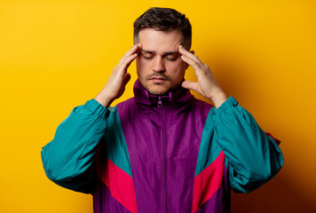 Style man in 90s tracksuit on yellow background