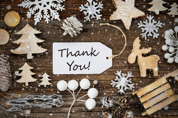 White Label With English Text Thank You. Frame Of Christmas Decoration Like Tree, Sled, Star And Fir Cone. Wooden Background With Snowflakes