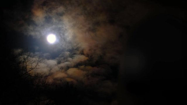Full moon in the night sky, full moon, night sky, the motion of clouds in the night sky against the background of a bright moon, Clouds in the night sky against a bright moon