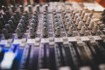 Shallow depth of field (selective focus) image with the controls on an audio mixer