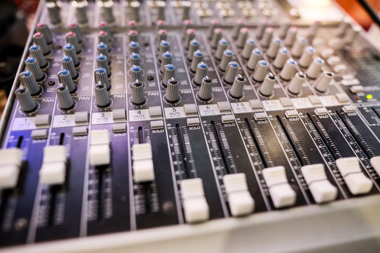 Shallow depth of field (selective focus) image with the controls on an audio mixer