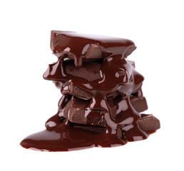 Chocolate pieces stack and chocolate syrup isolated on white background. Close up.