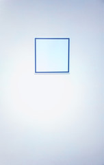 Empty square plate on office wall background