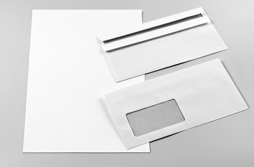 Blank Letterhead and Two Envelopes over Grey Background
