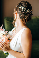 Beautiful bride showing her hairstyle. Diadem in the hair © Yuliia