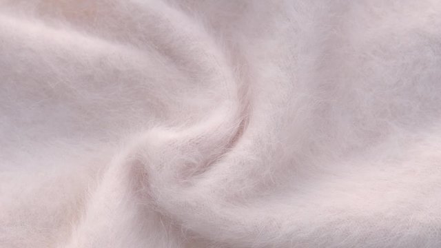 Soft fluffy jersey rotates. Soft Wool background.