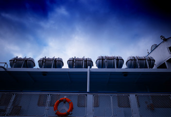 Five lifeboat on the ship under dark blue sky background