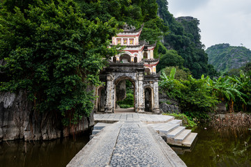 Fototapeta premium Beautiful Bich Dong Pagoda entrance in Tam Coc, Ninh Binh, Northern Vietnam shot in October 2019 on a bright day