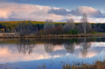 Autumn landscape by the river at sunset. Wonderful nature, beautiful natural background.