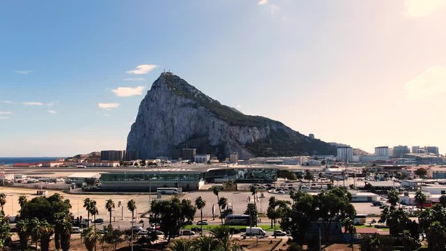 Rock of Gibraltar known as one of the two Pillars of Hercules. also view of Gibraltar Airport, and small park with palms