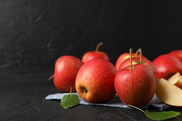 Apples and kitchen towel on black background, close up