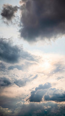 Beautiful sunny cloudscape in pastel colors of blue, white and yellow.