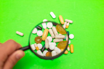  Pills, tablets and capsules from assorted pharmaceuticals in the background. Different Pills for health.