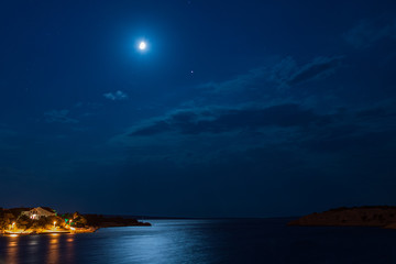 Deep blue moonlight ocean at night with calm waves in Croatia