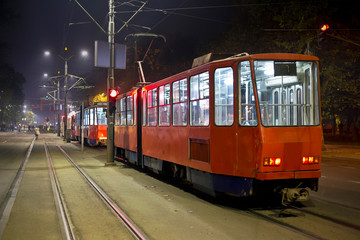 Fototapeta na wymiar Red trams in the night