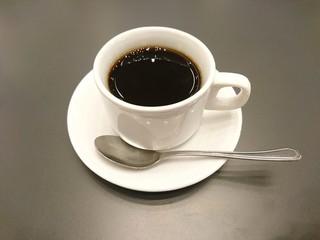 cup of black coffee with a spoon on wooden table [2119]