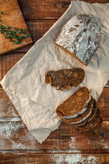 Freshly baked wheat bread, homemade cakes, still life with bread, crisp loaf of bread, still life on a rustic background, top view, rustic bread, roll, loaf.