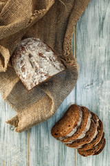 Freshly baked wheat bread, homemade cakes, still life with bread, crisp loaf of bread, still life on a rustic background, top view, rustic bread, roll, loaf.