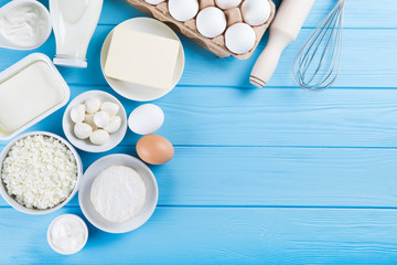 Dairy products on wooden table. Milk, cheese, egg, curd cheese and butter.