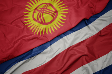 waving colorful flag of costa rica and national flag of kyrgyzstan.