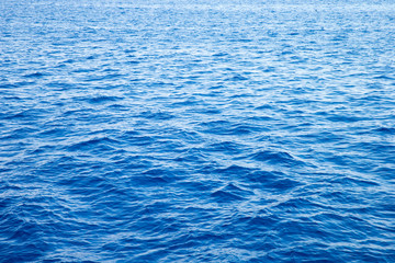 Sea background . Blue water with sun reflections
