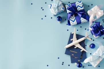 Christmas travel planning. Traveling as gift. Toy airplane with passports and gift boxes.