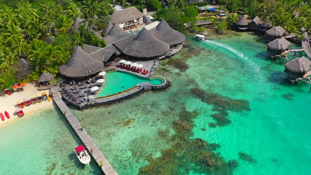 Aerial of an amazing tropical Area, drone flying forward then turning from left to right, showing overwater bungalows under construction - Bora Bora, French Polynesia
