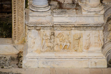 Bas-reliefs of antique scenes on the gables of the amphitheater in Hierapolis, Turkey.