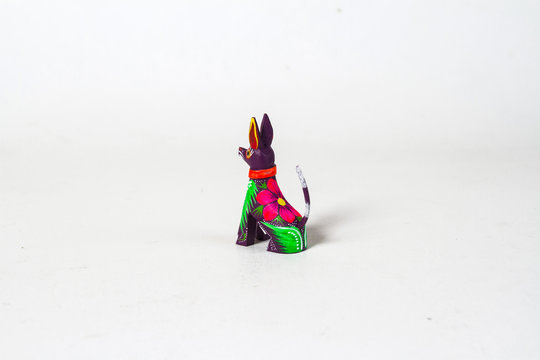Mexican purple xolo dog alebrije from oaxaca isolated on white background. Back view