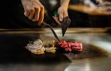 teppan show in a Japanese restaurant, cooking directly in front of the client, fish, rice, meat, vegetables