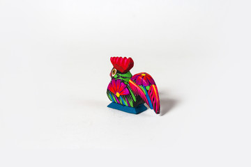 Mexican red rooster alebrije from oaxaca isolated on white background. Back shot