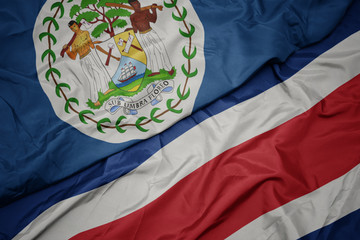 waving colorful flag of costa rica and national flag of belize.