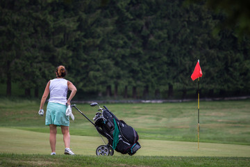Obraz premium Two women on a golf course with trolleys