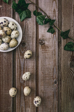 Chicken eggs. Minimalistic still life on a dark old vintage wooden background. Top view Selective focus. Cardboard packaging for eggs.