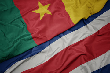 waving colorful flag of costa rica and national flag of cameroon.