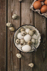 Chicken eggs. Minimalistic still life on a dark old vintage wooden background. Top view Selective focus. Cardboard packaging for eggs.