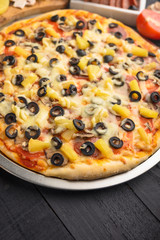 Italian pizza and ingredients. Pizzeria, restaurant, recipe book, home cooking. Vertical photo with space for design.