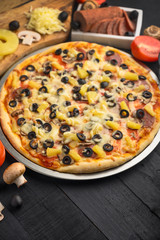 Italian pizza and ingredients. Pizzeria, restaurant, recipe book, home cooking. Vertical photo with space for design.