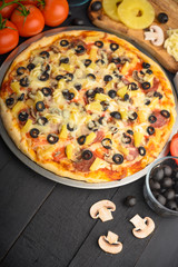 Italian pizza and ingredients. Pizzeria, restaurant, recipe book, home cooking. Vertical photo with space for design.