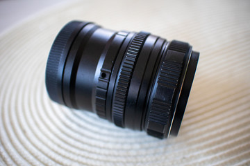 Old vintage manual photo lens with adapter for modern mirrorless camera