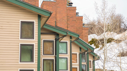Panorama frame Townhomes with snow covered mountain and cloudy sky background in winter